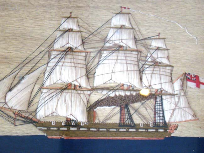 A charming 19th century sailor-made woolwork picture of a British steam and sail ship circa 1865 in what appears to be its' original frame.